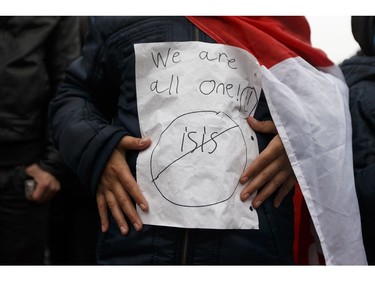 Rami Issa, 12, holds an anti-ISIS sign during the Stand Together Against Violence in Solidarity with EPS vigil organized by Alberta Muslim Public Affairs Council at Churchill Square in Edmonton, Alberta after a police officer and four bystanders were injured in a terrorist attack on Sunday, October 1, 2017.