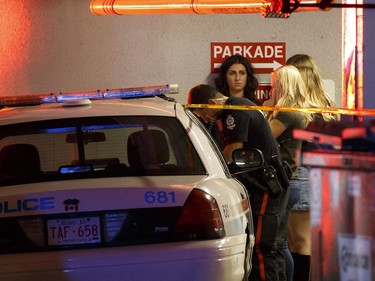 Bar patrons are interviewed by a police officer outside The Pint bar on 109 Street near Jasper Avenue following a high speed chase where several pedestrians were struck.