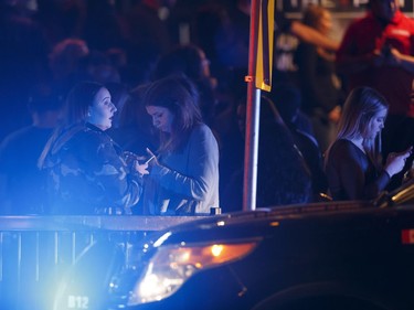 Bar patrons are seen outside the The Pint bar on 109 Street near Jasper Avenue after Edmonton Police officers arrested a man nearby following a high-speed chase.