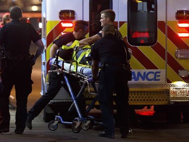 An person is loaded on to an ambulance outside The Pint bar on 109 Street near Jasper Avenue after Edmonton police officers arrested a man following a high-speed chase.