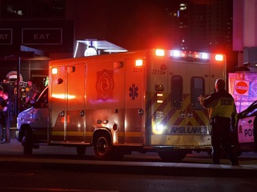 An injured person is loaded on to an ambulance outside The Pint bar on 109 Street near Jasper Avenue after Edmonton Police  officers arrested a man nearby following a high-speed chase, where several pedestrians were run down.