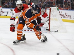 Edmonton's Anton Slepyshev battles Carolina's Trevor Carrick (46) during the second period of a NHL game between the Edmonton Oilers and the Carolina Hurricanes at Rogers Place in Edmonton, Alberta on Tuesday, October 17, 2017.