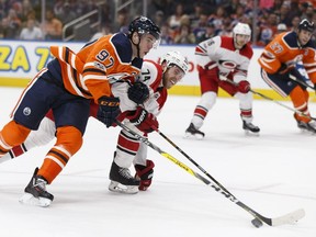 Edmonton's Connor McDavid (97) battles Carolina's Jaccobb Slavin (74) during the second period of a NHL game between the Edmonton Oilers and the Carolina Hurricanes at Rogers Place in Edmonton, Alberta on Tuesday, October 17, 2017.