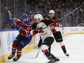 Edmonton's Tomas Soustal (11) is hit by Prince George's Adam Kadlec (11) during the second period of a WHL game between the Edmonton Oil Kings and the Prince George Cougars at Rogers Place in Edmonton, Alberta on Friday, October 20, 2017.