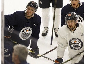 Edmonton Oilers' Connor McDavid (97) and Anton Slepyshev (58) listen as head coach Todd McLellan (bottom left) instructs players during a practice at the Edmonton Downtown Community Arena in Edmonton, Alberta on Friday, October 27, 2017.