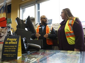 Sean Akbar, manager of the Husky Energy Inc. gas station at 344/348 Bulyea Road, gives Minister of Labour Christina Gray a tour in Edmonton, Alberta on Monday, Oct. 30, 2017 as gas and dash legislation is introduced for mandatory pre-payment of gasoline to protect workers.