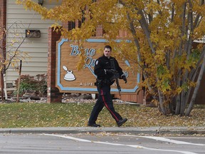 Edmonton Police Officer with a long gun west of 119 Street near 28 Ave. David Bloom/Postmedia