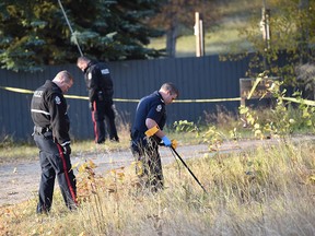 Edmonton police search for evidence near 44 Avenue and 211 Street on Oct. 4, 2017. The driver of a vehicle was shot by an officer after ramming into a police vehicle, running over an officer's foot and trying to flee on Tuesday night.