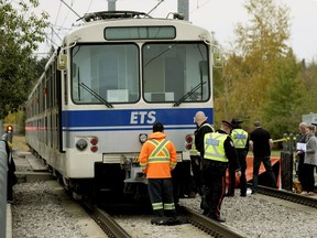 Investigators at 115A Street and 60 Avenue where a 22-year-old pedestrian who was wearing earbuds was fatally struck by an LRT train Friday Oct. 6, 2017, said city police.