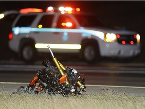 The remains of a motorcycle lies on the side of the road on Anthony Henday Drive near Terwillegar Drive on Sunday, Oct. 29, 2017, where police are investigating a serious collision.