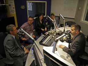 Edmonton's newly-elected city councillors Tim Cartmell, left, John Dziadyk, Sarah Hamilton and Aaron Paquette talk to 630 CHED radio show host Ryan Jespersen, right, at the station on Tuesday, Oct. 17, 2017.