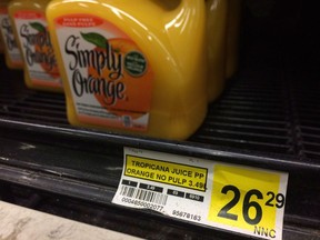A price tag lists the price of a jug of orange juice at a grocery store in Iqaluit, Nunavut on Dec. 8, 2014. File photo.