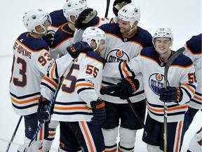 Edmonton Oilers' Mark Letestu (55) celebrates with teammates after scoring against the Chicago Blackhawks in overtime of an NHL hockey game Thursday, Oct. 19, 2017, in Chicago. The Oilers own 2-1.