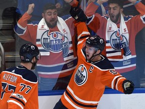 Edmonton Oilers Connor McDavid (97) celebrates with Oscar Klefbom (77) his first goal of the game against the Calgary Flames during the season opener of NHL action at Rogers Place in Edmonton, October 4, 2017.