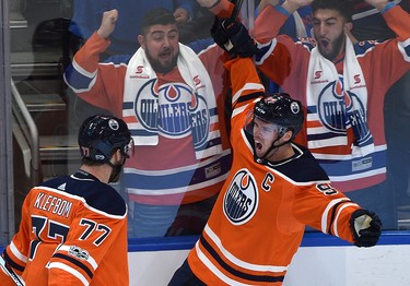 Edmonton Oilers Connor McDavid (97) celebrates with Oscar Klefbom (77) his first goal of the game against the Calgary Flames during the season opener of NHL action at Rogers Place in Edmonton, October 4, 2017.