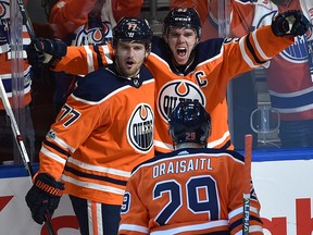 Edmonton Oilers Connor McDavid (97) celebrates with Oscar Klefbom (77) and Leon Draisaitl (29) his first goal of the game against the Calgary Flames during the season opener of NHL action at Rogers Place in Edmonton, October 4, 2017. Ed Kaiser/Postmedia (Edmonton Journal story by Jim Matheson)