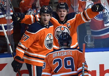 Edmonton Oilers Connor McDavid (97) celebrates with Oscar Klefbom (77) and Leon Draisaitl (29) his first goal of the game against the Calgary Flames during the season opener of NHL action at Rogers Place in Edmonton, October 4, 2017. Ed Kaiser/Postmedia (Edmonton Journal story by Jim Matheson)