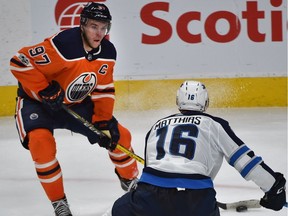 Edmonton Oilers star Connor McDavid tries to pass the puck through Winnipeg Jets Shawn Matthias during NHL action at Rogers Place in Edmonton, October 9, 2017. Ed Kaiser/Postmedia
Ed Kaiser