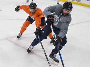 Adam Larsson and Patrick Maroon jostle  in the corner during Edmonton oilers practice on Oct. 5, 2017, at Rogers Place.