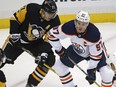 Pittsburgh Penguins forward Evgeni Malkin, left, works for position against Edmonton Oilers captain Connor McDavid during NHL action on Oct. 24, 2017, in Pittsburgh.