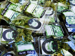 This July 1, 2014, photo shows packets of a variety of recreational marijuana named "Space Needle" during packaging operations at Sea of Green Farms in Seattle.