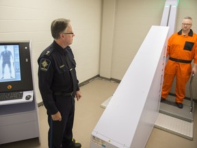Ken Johnston, director of security at the Edmonton Remand Centre, demonstrates new body-scanning equipment installed as part of a pilot project to reduce the amount of contraband entering the facility this fall. There have been hundreds of recorded overdoses in Alberta correctional facilities in the past few years, data obtained by Postmedia shows.