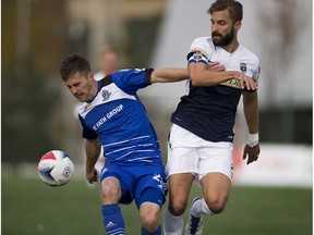 FC Edmonton's Jake Keegan and Jacksonville Armada FC Tyler Ruthven battle for the ball at Clarke Field on Sunday, October 23, 2016 in Edmonton.