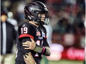 Calgary Stampeders quarterback Bo Levi Mitchell holds his arm as he walks off the field against the Saskatchewan Roughriders during CFL football on Friday, October 20, 2017.