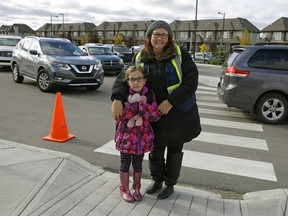Leah Ison with her daughter Audrey (7-years-old) outside Magaret-Ann Armour School. Ison would like to see more photo radar around the school, on Ellerslie Road where the kids are crossing and in the neighbourhoods.