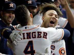 Astros' Yuli Gurriel (right) is congratulated by George Springer after hitting a home run during the second inning of Game 3 of the World Series against the Dodgers in Houston on Friday, Oct. 27, 2017. (David J. Phillip/AP Photo)