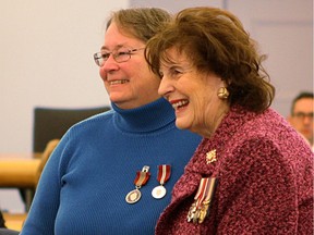 Lezley Zwaal, left, founder of Quilts of Valour, smiles for a photo after receiving a Sovereign's Medal for Volunteers from Lt.-Gov. Lois Mitchell, right, at a special ceremony at Government House on Tuesday, Oct. 17, 2017. Her organization has donated nearly 10,000 handmade quilts to veterans.