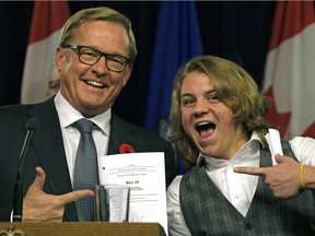 Alberta Education Minister David Eggen, left, and transgender student Ace Peace with a copy of Bill 24 at the Alberta legislature on Thursday, Nov. 2, 2017. The bill strengthens gay-straight alliance legislation in Alberta.