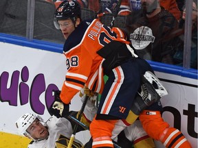 Edmonton Oilers forward Jesse Puljujarvi takes down Vegas Golden Knights defenceman Brad Hunt during NHL action at Rogers Place on Nov. 14, 2017.