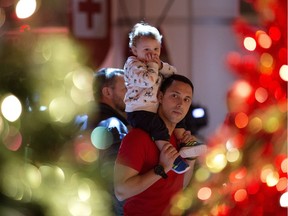Riley Curtis and his son Isaac Curtis, 1, look at the Christmas Trees on display during the 32nd Annual Festival of Trees at the Shaw Conference Centre, in Edmonton on Thursday, Nov. 24, 2016.