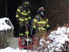 Firefighters continue to work at a home near 156 Avenue and 98 Street in Edmonton on Friday, Nov. 3, 2017.