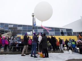 Crews prepare to launch of a weather balloon at the Telus World of Science, in Edmonton Friday Nov. 10, 2017.