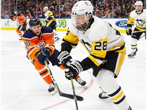 Kailer Yamamoto #56 of the Edmonton Oilers pursues Ian Cole #28 of the Pittsburgh Penguins at Rogers Place on November 1, 2017 in Edmonton, Canada.