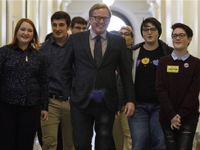 Education Minister David Eggen walks with kids on his way to speak about the passing of Alberta's controversial gay-straight alliance bill in Edmonton Alta, on Wednesday Nov. 15, 2017.