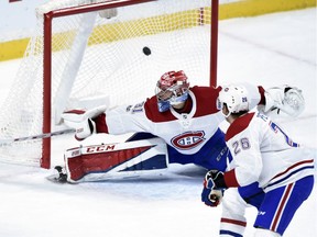 Canadiens' Jeff Petry (26) watches a goal whiz past struggling Carey Price during first period Thursday night in Minnesota.