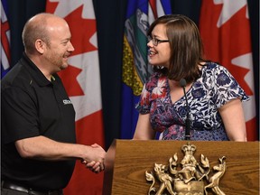 Jeff Mooij, owner of 420 Clinic shakes hands with Alberta Justice Minister Kathleen Ganley at the Legislature in Edmonton, on Nov. 16, 2017.