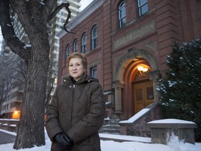Cindy Davis, manager of the Edmonton Public Schools Archives and Museum, in front of McKay Avenue School, one of the city's earliest schoolhouses and site of Alberta's first Legislative Assembly.