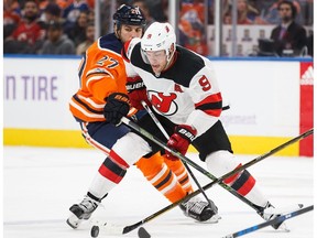 Milan Lucic #27 of the Edmonton Oilers battles against Taylor Hall #9 of the New Jersey Devils at Rogers Place in Edmonton on Friday, Nov. 3, 2017.