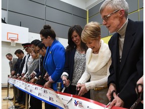 Denise and David Woodall, far right, parents of Constable Daniel Woodall, help cut the ribbon as the community celebrates the official opening of Constable Daniel Woodall School in Edmonton, November 15, 2017.