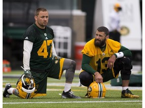 Edmonton Eskimo players J.C. Sherritt and Mike Reilly relax of a moment during practice on Friday June 9, 2017, at Commonwealth Stadium in Edmonton.