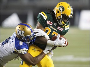 Winnipeg Blue Bombers' Chris Randle (8) tackles Edmonton Eskimos' Derel Walker (87) during second half CFL action in Edmonton.