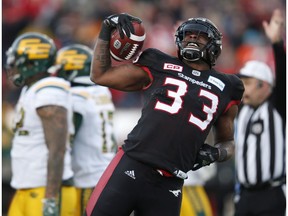 Calgary Stampeders' Jerome Messam (33) celebrates his two point conversion in front of the Edmonton Eskimos during second quarter CFL West Final football action in Calgary, Sunday, Nov. 19, 2017.