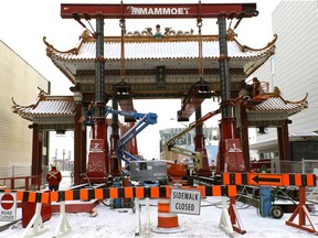 Workers dismantle the Harbin Gate in downtown Edmonton's Chinatown on Nov. 4, 2017. The gate was removed from its foundation on the weekend and moved to a City of Edmonton storage facility.