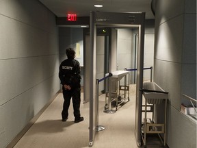 A security guard awaits visitors to council chambers at Edmonton City Hall in Edmonton, Alberta on Tuesday, Oct.31, 2017. Increased security measures including metal detectors and searches are in place following the 2017 municipal election.