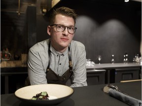 Alder Room chef and co-owner Ben Staley poses for a photo with the restaurant's beet root, blueberries and hay cream dish in Edmonton, Alberta on Wednesday, Nov. 1, 2017.