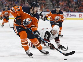 Edmonton Oilers defenceman Oscar Klefbom, left, shoots past Arizona Coyotes forward Max Domi during NHL action on Nov. 28, 2017, at Rogers Place.